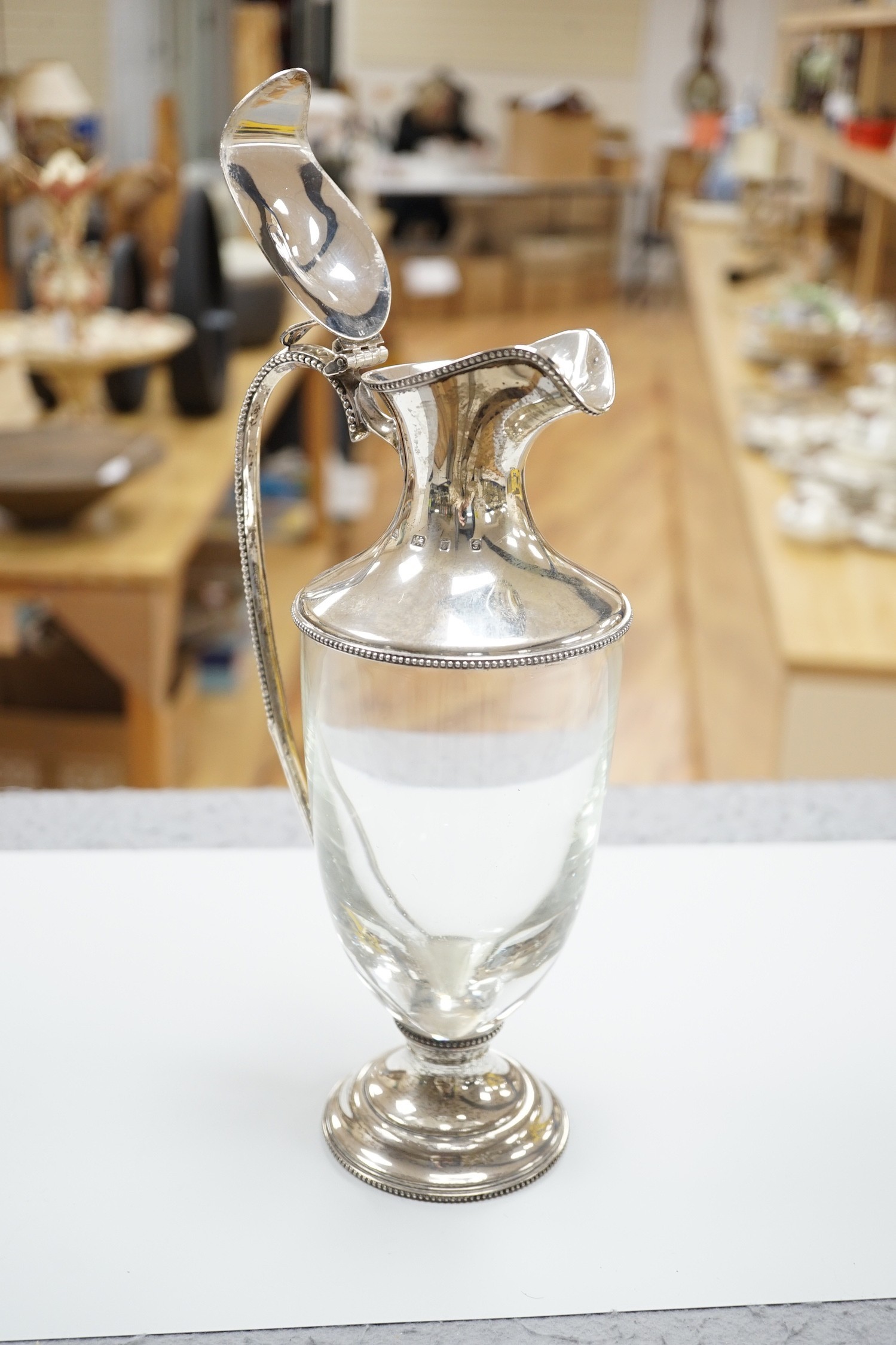 A modern silver mounted glass urn shaped claret jug, on pedestal foot, J A Campbell, London, 1981, 27.2cm.